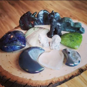 Assorted Crystal Carvings - aura moon, sodalite heart, yooperlite sphinx, serpentine heart, clear quartz moon, bloodstone unicorn, howlite dog and cat, labradorite cloud and moss agate clous